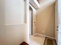 Inviting entryway features neutral paint, tile floors, and an arched doorway, creating a warm welcome at 15822 Woodland Spring Ct, Orlando, FL 32828