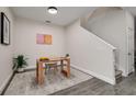Bright home office featuring a wooden desk, neutral chair, and tasteful decorations under the stairs at 1624 Little Wren Ln, Winter Park, FL 32792