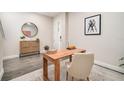 Serene home office boasts stylish decor, a wooden desk, and a round mirror over a cabinet at 1624 Little Wren Ln, Winter Park, FL 32792