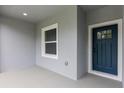 Close-up of front porch, showcasing a sleek door and window with clean lines and a modern aesthetic at 17397 Sw 41St Cir, Ocala, FL 34473