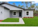 Inviting front porch with clean lines and landscaping offering curb appeal to this lovely, modern home at 17397 Sw 41St Cir, Ocala, FL 34473