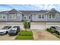 Attractive townhome exterior featuring muted blue siding, two-car garages, and manicured landscaping at 1932 Terrapin Rd, Ocoee, FL 34761