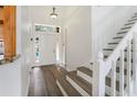 Welcoming foyer with hardwood floors, a staircase, and a clear view of the front door and outdoor space at 1932 Westpointe Cir, Orlando, FL 32835