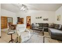 Cozy living room featuring a comfortable sectional, plush rug, and dining area with a wooden table at 2180 Captain Dr, Deltona, FL 32738