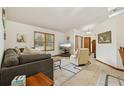 Inviting living room with a neutral color palette, tile flooring, and sunlit windows at 2180 Captain Dr, Deltona, FL 32738