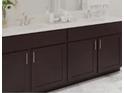 Bathroom vanity with dark cabinetry, light countertops, and modern fixtures at 3021 Namaste Dr, Clermont, FL 34714