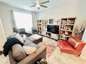 Comfortable living room with a sectional sofa, modern decor, and ample natural light, perfect for relaxation at 3118 Crown Jewel Ct, Winter Park, FL 32792