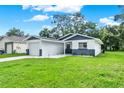 Well-maintained home with a green lawn, and a driveway leading to a single-car garage at 324 James Pl, St Cloud, FL 34769