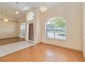 Bright dining area showcasing a modern chandelier and large window at 3250 Sawgrass Creek Cir, St Cloud, FL 34772