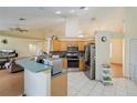 Open kitchen with modern appliances, tile backsplash, and breakfast bar at 3250 Sawgrass Creek Cir, St Cloud, FL 34772