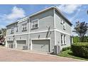 Townhouse exterior with gray paint and brick paver driveway at 335 Lansbrook Ln, Winter Springs, FL 32708