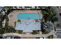 Aerial view of a community pool with sun loungers and lush tropical landscaping at 335 Lansbrook Ln, Winter Springs, FL 32708
