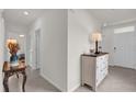 Bright entryway featuring neutral walls, ceramic tile and a decorative table at 336 Pelham Park Dr, Deland, FL 32720