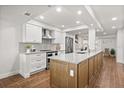 Modern kitchen featuring white cabinetry, stainless steel appliances, and a large island with granite countertops at 4621 S Atlantic Ave # 7202, Port Orange, FL 32127