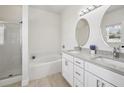 Bright bathroom with double sinks, granite countertops, soaking tub and separate shower stall at 504 Key Haven Dr, Sanford, FL 32771