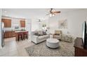 Inviting living room featuring tile floors and comfortable seating arrangement adjacent to kitchen at 504 Key Haven Dr, Sanford, FL 32771
