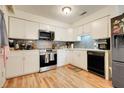 Modern kitchen with white cabinets, stainless steel appliances, and beautiful countertops at 5323 Hansel Ave # E14, Orlando, FL 32809