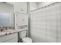 Cozy bathroom featuring a shower/tub combo and built-in storage above the toilet for convenience at 5395 Sunshine Dr, Wildwood, FL 34785