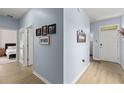 Inviting entryway with light blue walls and luxury vinyl plank flooring leading into the living spaces at 5395 Sunshine Dr, Wildwood, FL 34785