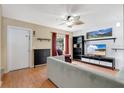 Inviting living room featuring wood floors, a ceiling fan, and cozy seating at 5662 Royal Pine Blvd # 24, Orlando, FL 32807