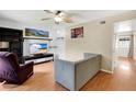 Bright living room with wood floors, sleek furniture, and natural light at 5662 Royal Pine Blvd # 24, Orlando, FL 32807