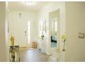 Welcoming entryway with hardwood flooring, elegant decor, and ample natural light at 608 Washington Way, Haines City, FL 33844