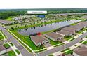 Aerial view of home highlighting its location, nearby lake, and community amenity center at 6348 Mossy Oak Rd, St Cloud, FL 34771