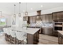 Stylish kitchen with island seating, pendant lights, and stainless appliances, perfect for gatherings at 6348 Mossy Oak Rd, St Cloud, FL 34771