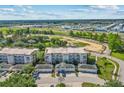 Overhead view showcasing the condo community's buildings, parking, landscaping, and surrounding areas at 7509 Mourning Dove Cir # 302, Reunion, FL 34747