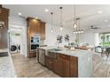 Modern kitchen featuring a large island with seating and stainless steel appliances at 8106 Mabury Ln, Orlando, FL 32832