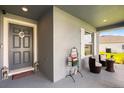 Inviting covered front porch with seating, decorative accents, and well-lit entry at 9020 Se 42Nd Ct, Ocala, FL 34480