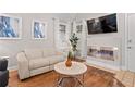 Cozy living room with hardwood floors, modern fireplace, and a comfortable white sofa at 938 Southridge Trl, Altamonte Springs, FL 32714