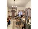 Cozy living room features decorative furnishings, a chandelier and tiled flooring at 1022 Love Ln # 35, Apopka, FL 32703