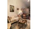 Cozy living room features decorative furnishings, painting of peacock and tiled flooring at 1022 Love Ln # 35, Apopka, FL 32703