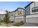 Inviting townhomes with modern design, two-car garages, and attractive landscaping create appealing neighborhood setting at 10293 Ebb Tide Ln, Orlando, FL 32821