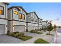 Charming townhomes showcase modern architecture, two-car garages, and a well-maintained, tree-lined street at 10293 Ebb Tide Ln, Orlando, FL 32821