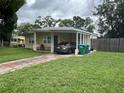 Single-story home with a covered carport and freshly cut lawn at 108 Country Club Cir, Sanford, FL 32771