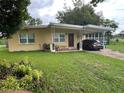 Quaint single-story home with a covered carport and well-maintained front lawn at 108 Country Club Cir, Sanford, FL 32771
