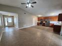 Spacious open-concept living room and kitchen area with modern tile flooring and stainless appliances at 11500 Benbow Ct, Orlando, FL 32837