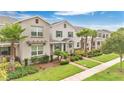Desirable townhome featuring beautiful landscaping, well-maintained lawn, and inviting curb appeal at 12015 Prologue Ave, Orlando, FL 32832
