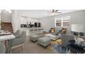 Bright living room with sleek flooring, modern decor, and a seamless open floor plan at 12015 Prologue Ave, Orlando, FL 32832
