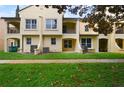 Rear exterior view of a yellow townhome with a well-maintained lawn at 1277 Blessing St, Maitland, FL 32751