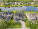 Stunning aerial view of a luxurious home on a tranquil lake at 16120 Bristol Lake Cir, Orlando, FL 32828