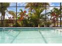 Inviting pool featuring beautiful tropical plants and a serene buddha statue at 16120 Bristol Lake Cir, Orlando, FL 32828