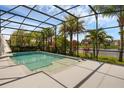 Relaxing screened-in pool area with tropical landscaping and serene water views at 16120 Bristol Lake Cir, Orlando, FL 32828