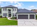 Charming two-story home featuring a three-car garage and well-manicured lawn at 201 Hammock Dunes Pl, Orlando, FL 32828