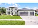 Charming two-story home featuring a three-car garage and well-manicured lawn at 201 Hammock Dunes Pl, Orlando, FL 32828