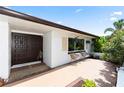 Inviting front entrance with a decorative double door and seating area, perfect for relaxing at 225 Temple Cir, Eustis, FL 32726