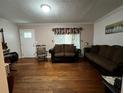 Inviting living room features hardwood floors, classic decor, and plenty of seating at 2429 S Laurel Ave, Sanford, FL 32771