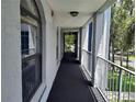 Outdoor hallway with windows and railings at 25210 Northlake Dr # 210, Sanford, FL 32773